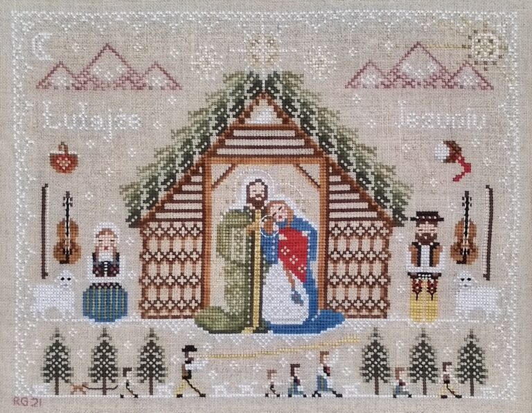 Polish Folk Nativity cross stitch design. Mary, Joseph, and baby Jesus in a shepherd's hut, surrounded by shepherds in Polish folk costume, with motifs of mountains, snowflakes, fiddles, sheep.